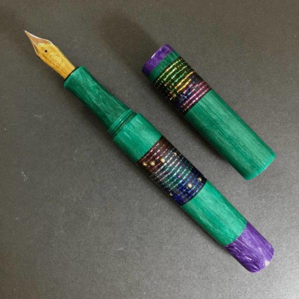 Uncapped pen and barrel side by side