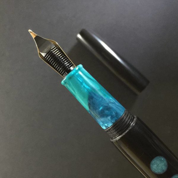 This side has a swirl of teal