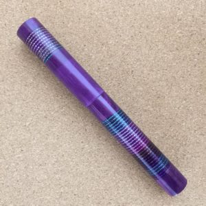 Image shows a cylindrical fountain pen with two strands of beads wrapped around the cap and around the barrel.
