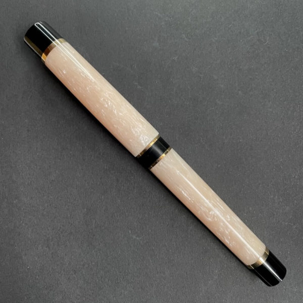 Fountain pen in a light cream colour with striations of pearlescence in the cream.